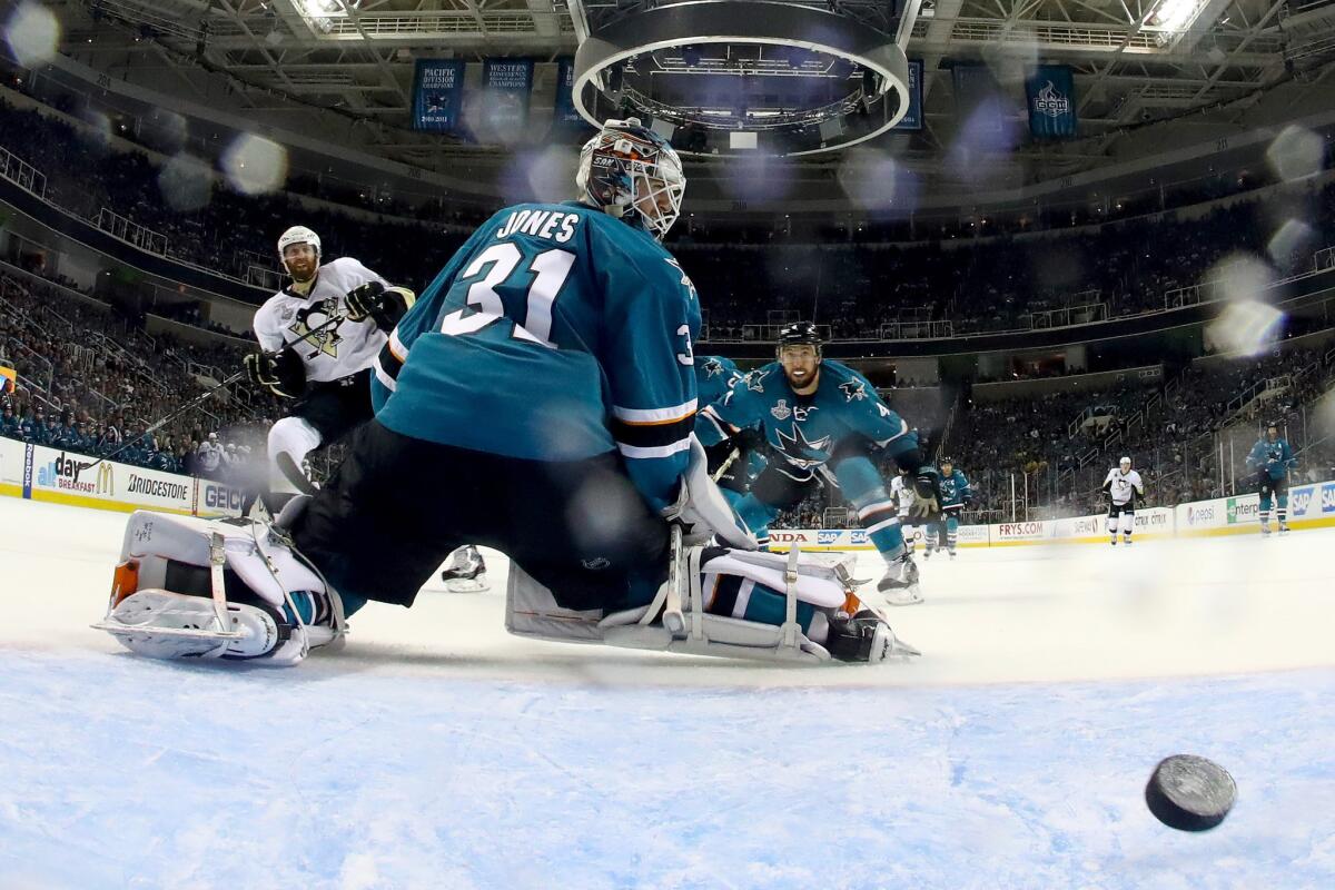 Sharks goalie Martin Jones looks back to see a goal by Penguins' Eric Fehr (16) in the third period of Game 4.