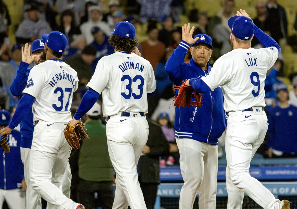 Dave Roberts high-fives his players.