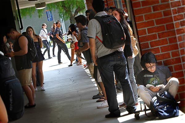 Students line up, waiting for math and business classes to start at Orange Coast Community College in Costa Mesa. California's community colleges have been experiencing an increase in student demand at the same time that the slow economy has forced state budget cuts, resulting in fewer classes being offered.