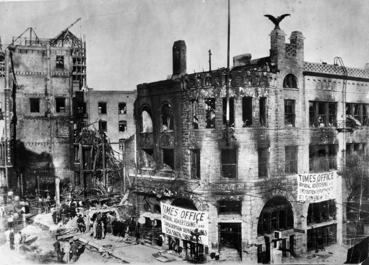Oct. 1910: The bombed-out Los Angeles Times building with poster announcing temporary locations of Times departments.