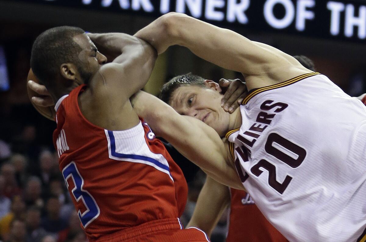 Chris Paul is called for a flagrant foul against the Cavaliers' Timofey Mozgov on Thursday in Cleveland.