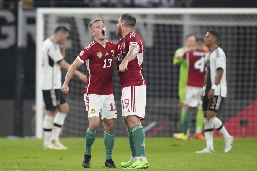 Hungary's Andras Schafer, left, and Hungary's Martin Ádám celebrate their victory in the UEFA Nations League soccer match between Germany and Hungary at the Red Bull Arena in Leipzig, Germany, Friday, Sept. 23, 2022. (AP Photo/Michael Sohn)