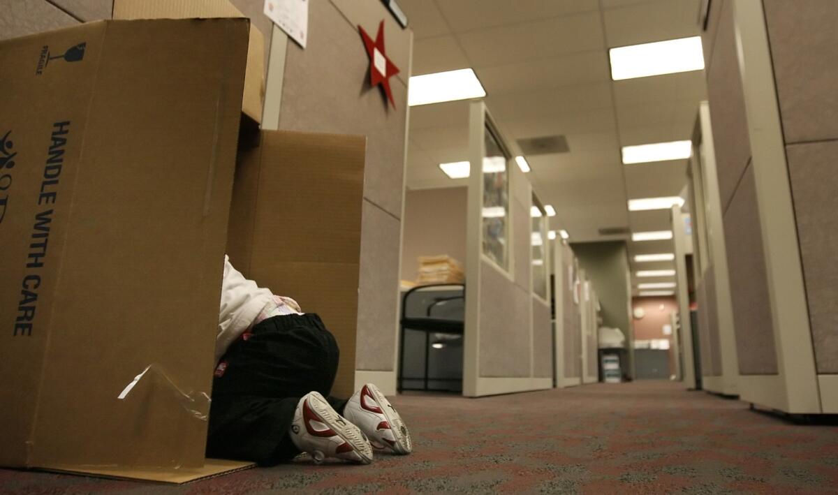 A young child removed from his home explores the halls of a Department of Children and Family Services office in Compton. The Los Angeles County foster care system reached crisis level this summer because of an uptick in child abuse reports.