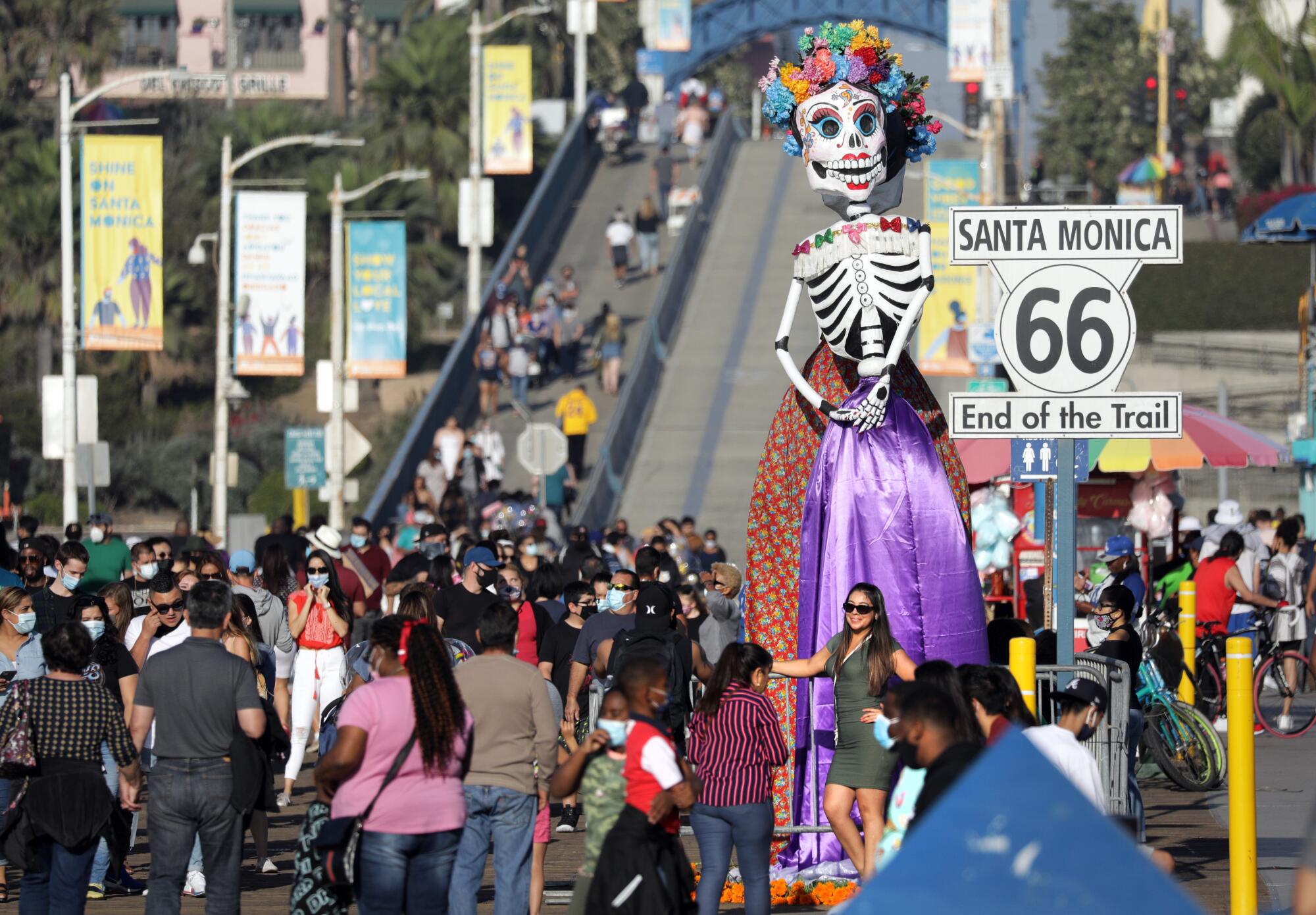 La estatua del Día de los Muertos saluda a la multitud en el muelle de Santa Mónica.