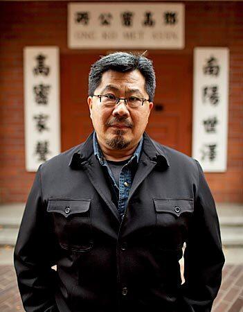 Steve Yee, a local artist, stands in front of a family association building in Sacramento's Chinatown. Yee's father was a "paper son," one of thousands of Chinese immigrants who came to the country illegally. Yee has traced his father's identity and past.