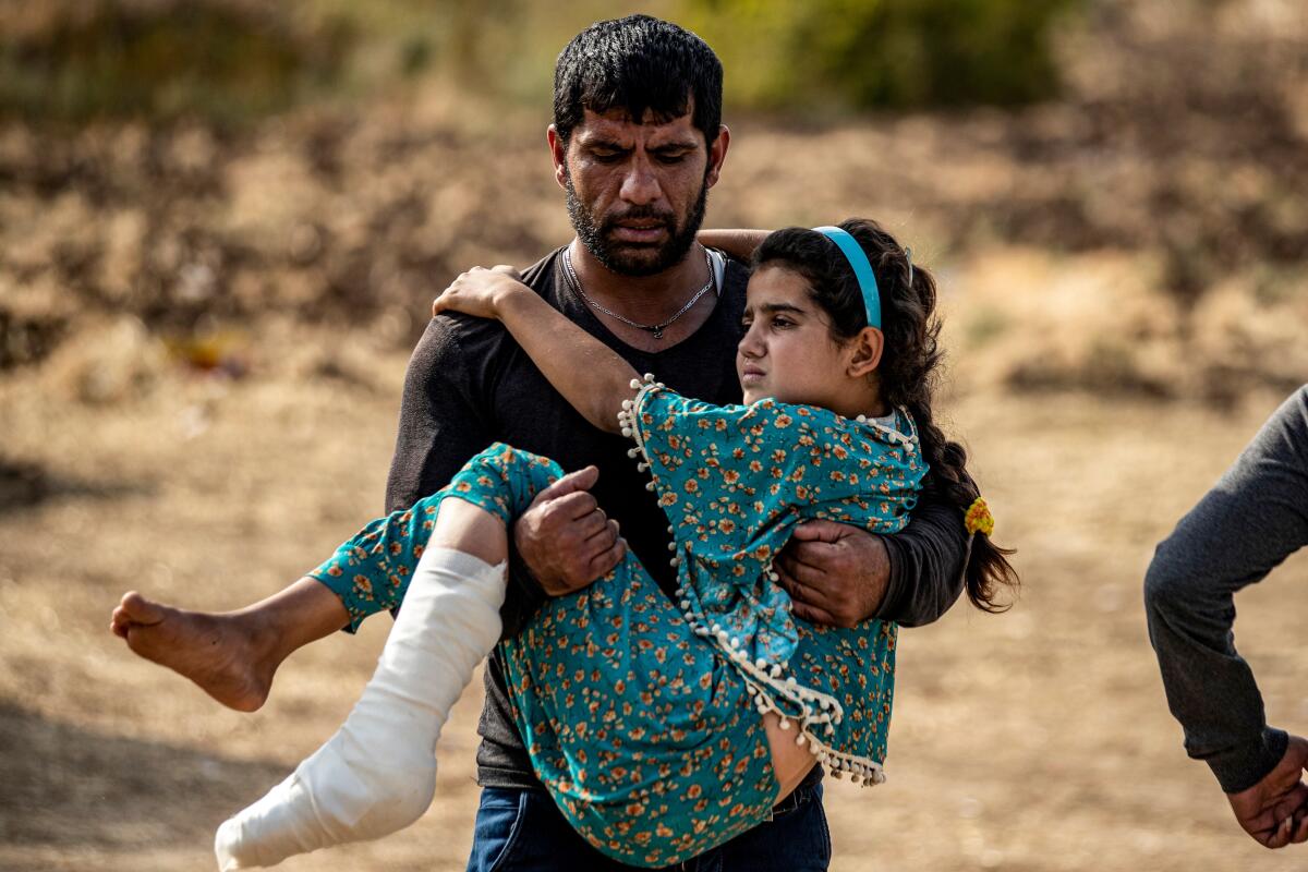 An injured Syrian Arab girl is carried away after receiving medical treatment last week at a hospital in Tal Tamr.