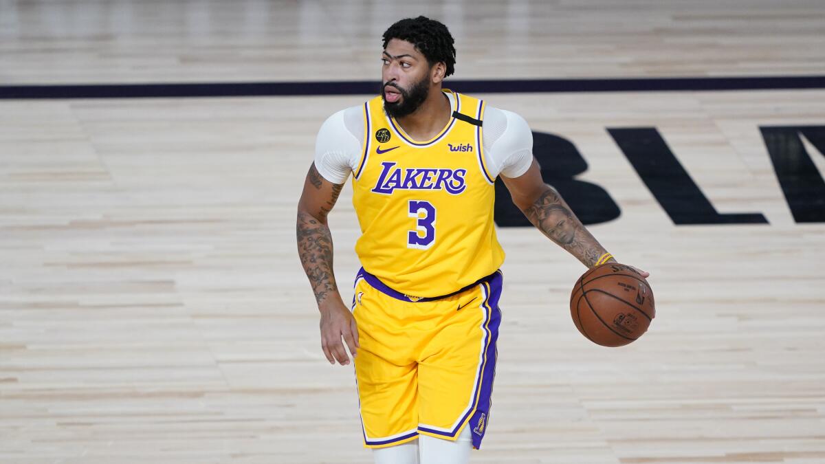 Lakers forward Anthony Davis controls the ball during a game.