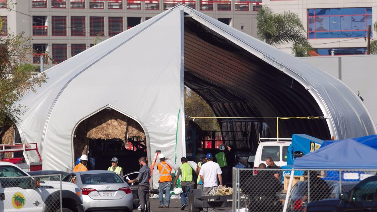 An industrial tent that will serve as "bridge housing" for many homeless people in San Diego is expected to open Friday in Logan Heights near Petco Park downtown.