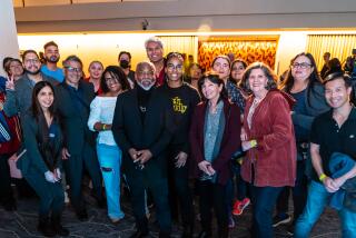 Actor and author LeVar Burton takes a photo with readers at the L.A. Times Book Club on May 24.