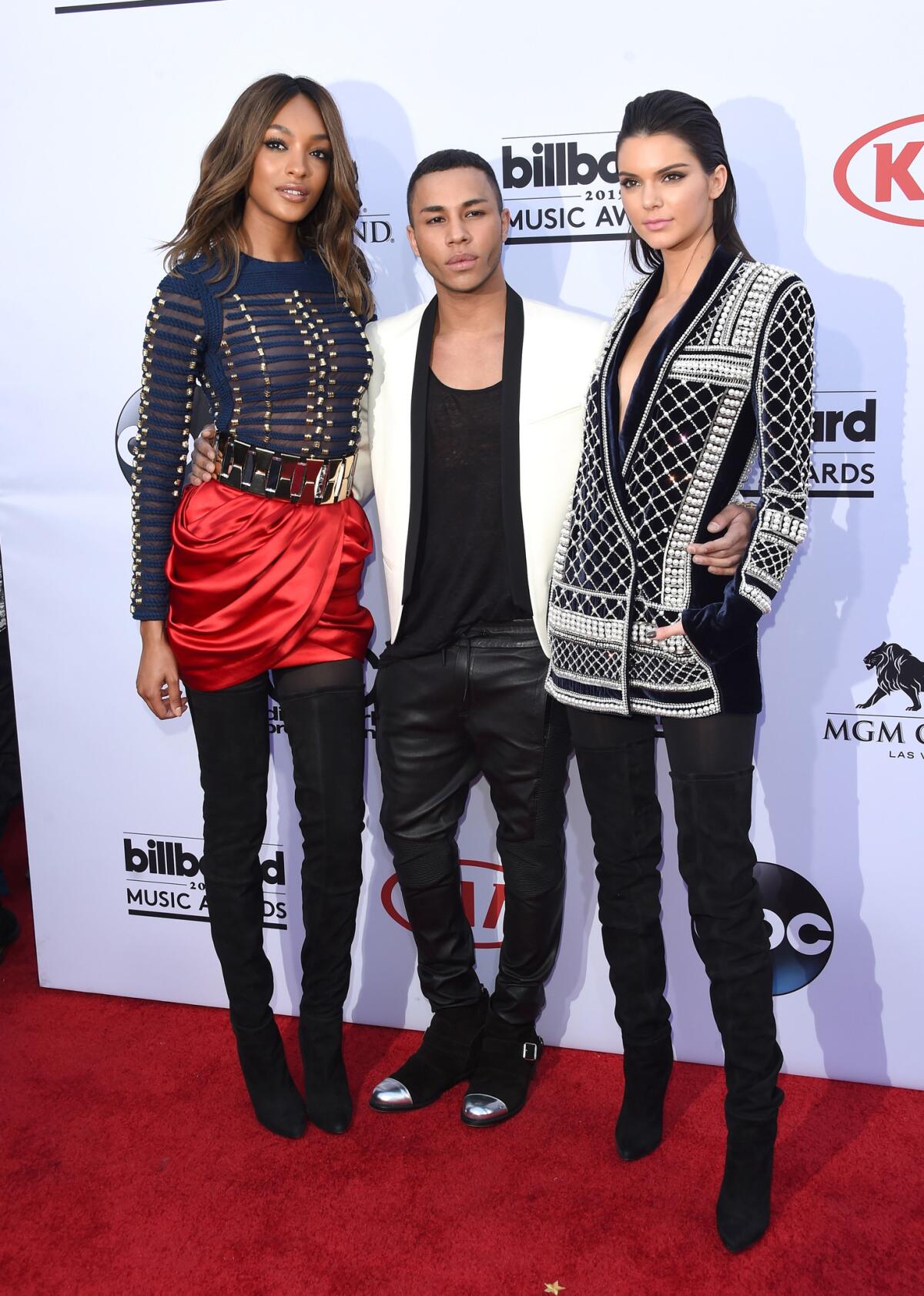 Model Jourdan Dunn, left, Balmain designer Olivier Rousteing and model Kendall Jenner, all wearing Balmain x H&M, attend the 2015 Billboard Music Awards.