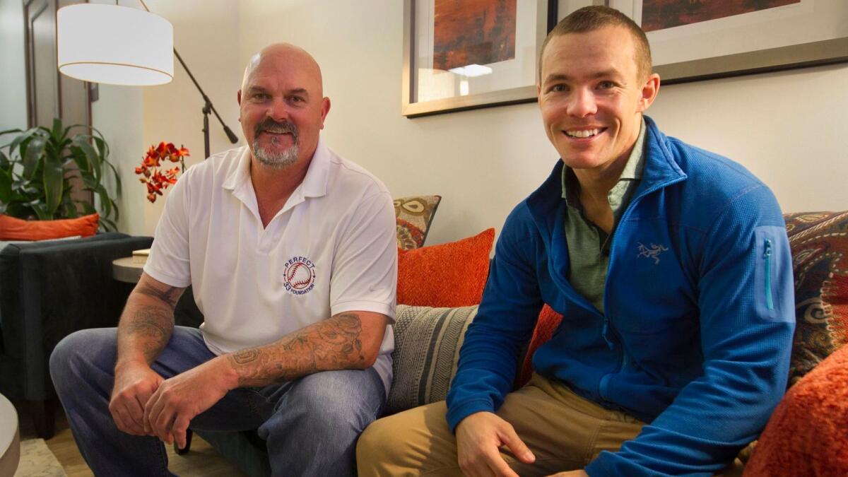 Former MLB pitcher David Wells (left), a Point Loma High School graduate from Ocean Beach, sits with former Navy SEAL Nick Norris in the offices of San Diego company PrTMS. Technology aided by Wells' $100,000 donation will assist about 10 SEALs readjusting to post-service life.