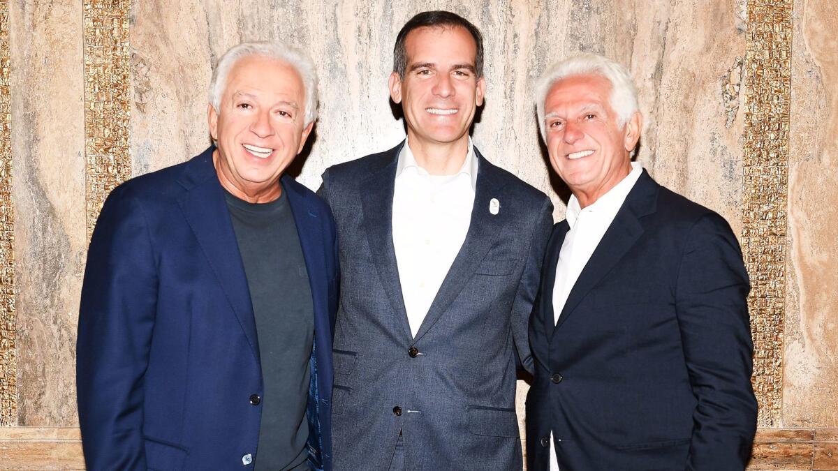 Los Angeles Mayor Eric Garcetti with Paul Marciano, left, and Maurice Marciano. (Billy Farrell / BFA.com)
