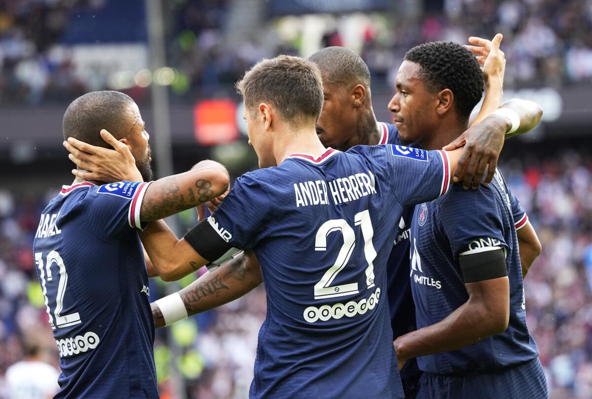 PSG's Ander Herrera, centre, celebrates with teammates after scoring his side's opening goal during the French League One soccer match between Paris Saint-Germain and Clermont at the Parc des Princes stadium in Paris, France, Saturday, Sept. 11, 2021. (AP Photo/Michel Euler)