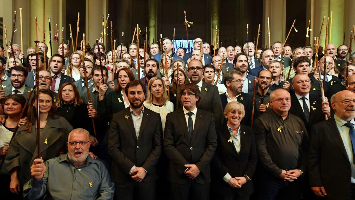 Ousted Catalan leader Carles Puigdemont, center, poses with Catalan mayors who traveled to Brussels to take part in an event in support of the ousted Catalan government on Tuesday, Nov. 7, 2017.