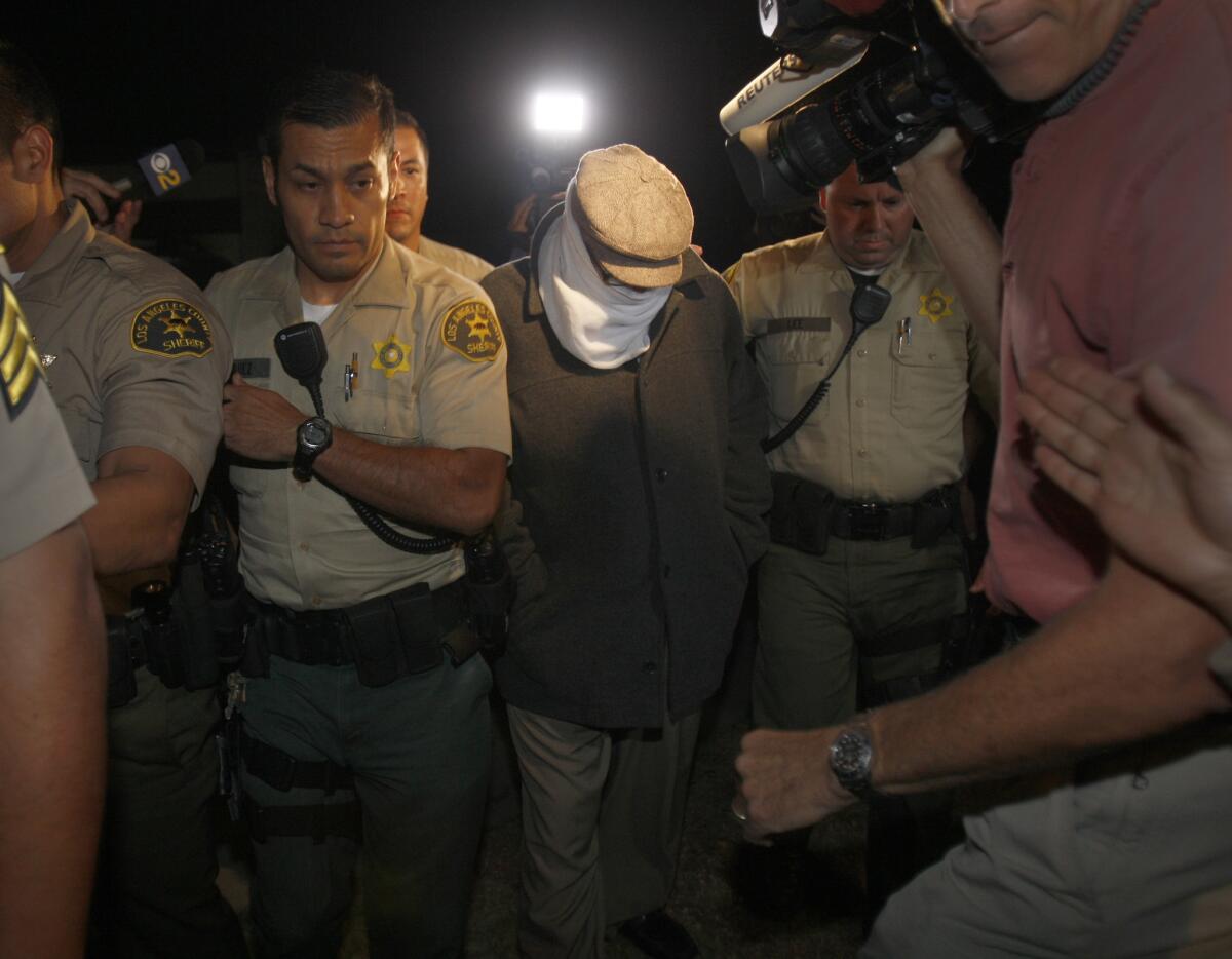 Los Angeles County Sheriff's deputies take Nakoula Basseley Nakoula into custody.