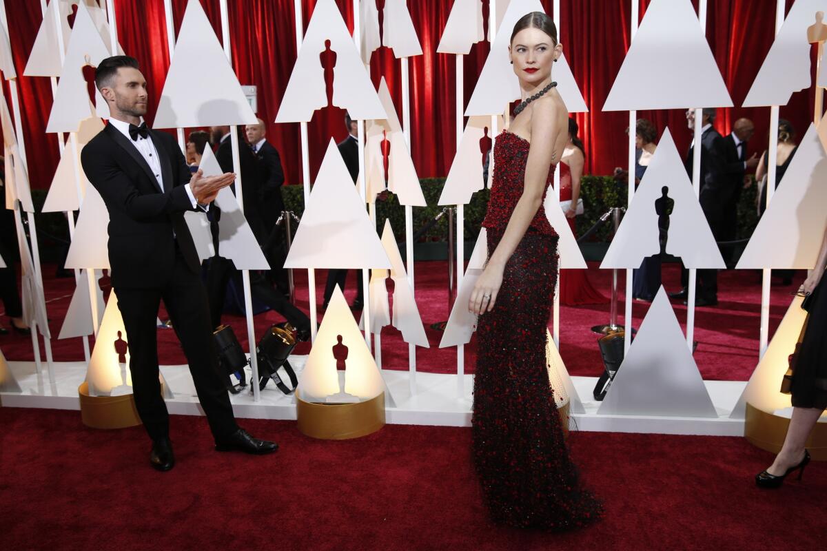 Singer Adam Levine and model Behati Prinsloo, arriving here at the 87th Academy Awards, are reportedly having a baby.