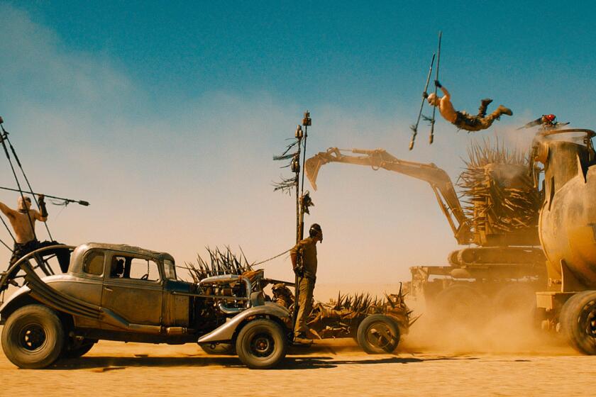***SUNDAY CALENDAR SNEAKS STORY FOR APRIL 26, 2015. DO NOT USE PRIOR TO PUBLICATION**********TOM HARDY (tied to front of car) as Max Rockatansky in Warner Bros. Pictures' and Village Roadshow Pictures' action adventure movie "MAD MAX: FURY ROAD," a Warner Bros. Pictures release. Photo Courtesy of Warner Bros. Pictures.