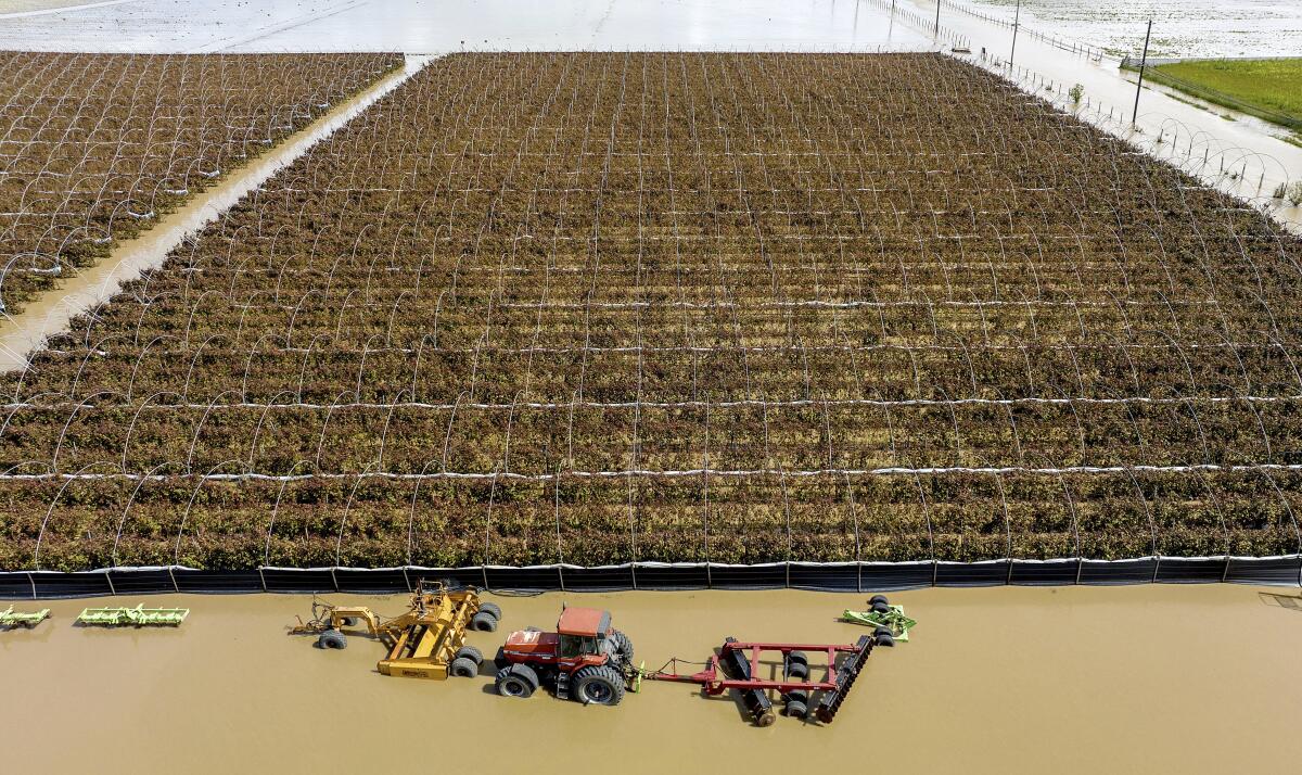 Floodwaters surround farm machinery in Pajaro in Monterey County in March 2023.
