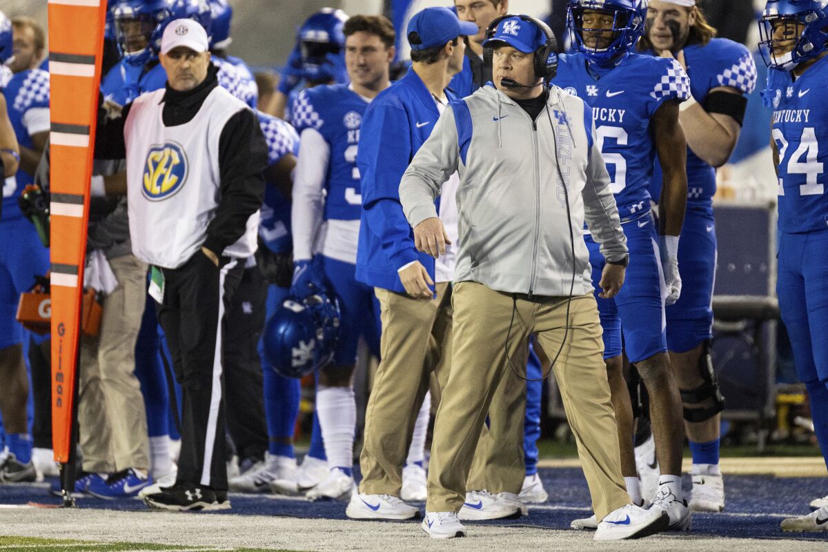 Kentucky head coach Mark Stoops watches his team from the sidelines during the first half of an NCAA college football game against Tennessee in Lexington, Ky., Saturday, Nov. 6, 2021. (AP Photo/Michael Clubb)
