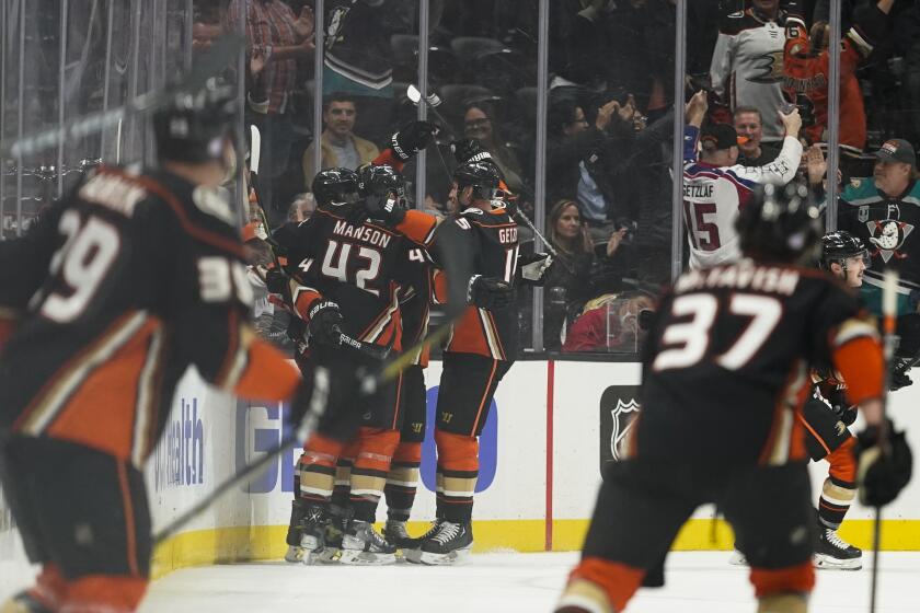 Anaheim Ducks celebrate after defenseman Cam Fowler (4) scored during the first period of an NHL hockey game against the Washington Capitals in Anaheim, Calif., Tuesday, Nov. 16, 2021. (AP Photo/Ashley Landis)