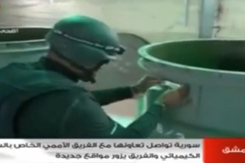 An image grab taken from Syrian television on Oct. 19 shows an inspector from the Organization for the Prohibition of Chemical Weapons (OPCW) at work at an undisclosed location in Syria.