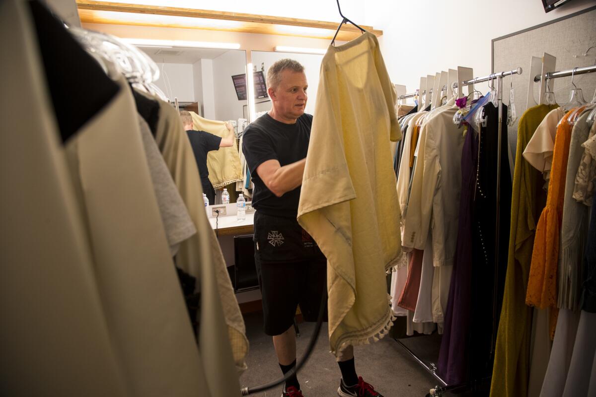 How many costumes in the extravaganza? Even the L.A. Phil has lost count. Here, Gary Marshaler steams some of the pieces backstage.