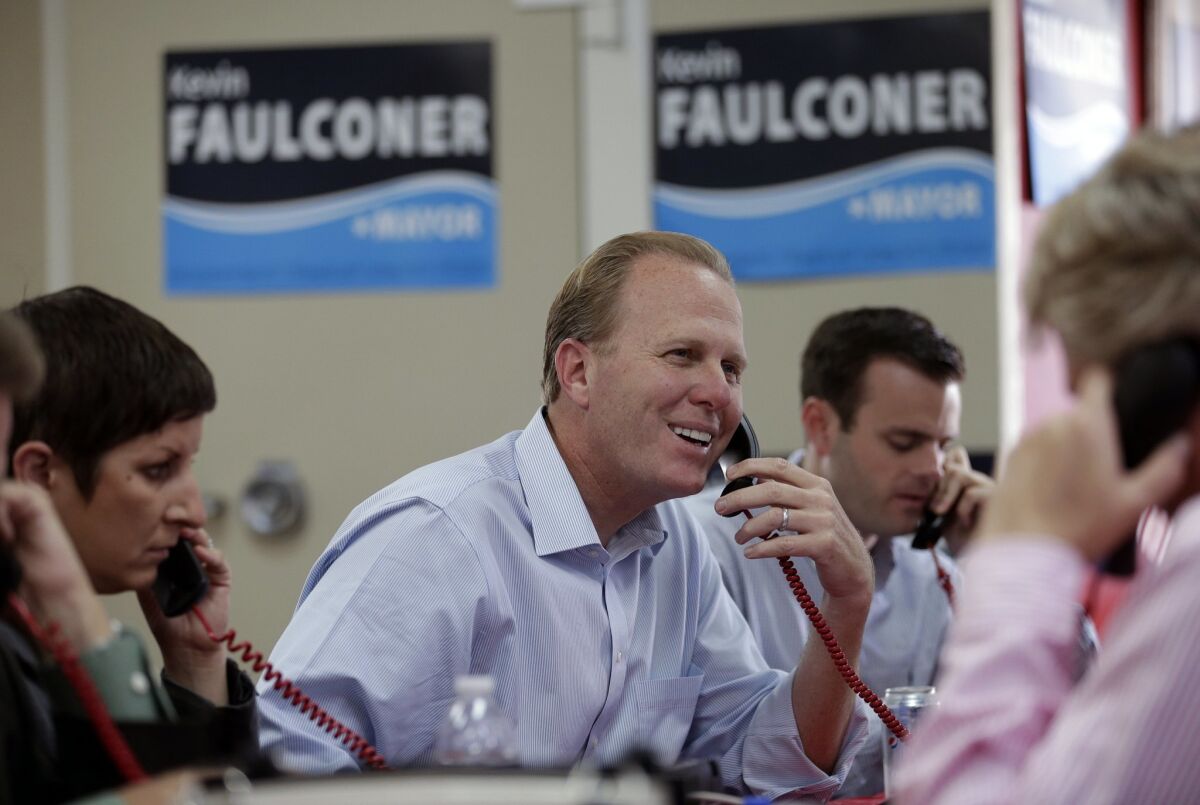 San Diego city councilman and Republican candidate for mayor, Kevin Faulconer smiles as he makes phone calls to voters during mayoral elections Tuesday, Nov. 19, 2013, in San Diego. San Diegans headed to the polls Tuesday to choose a new mayor, after Bob Filner's resignation amid allegations of sexual harassment has left the city with an interim mayor. (AP Photo/Gregory Bull) The Associated Press