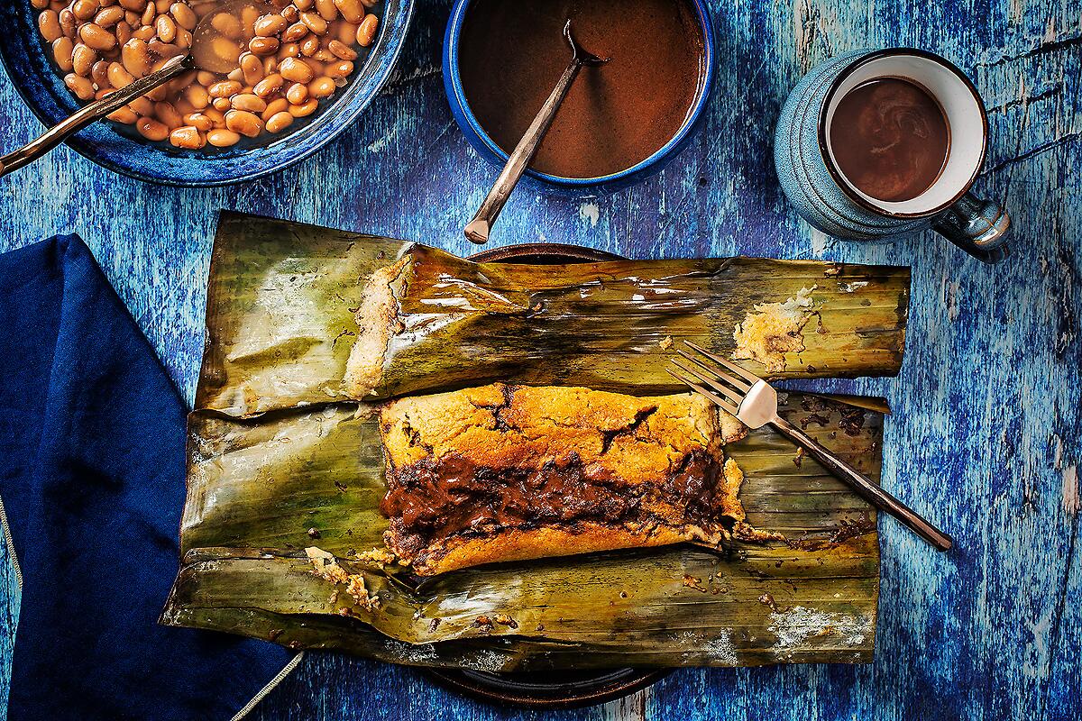 Chicken mole tamal wrapped in a banana leaf. 