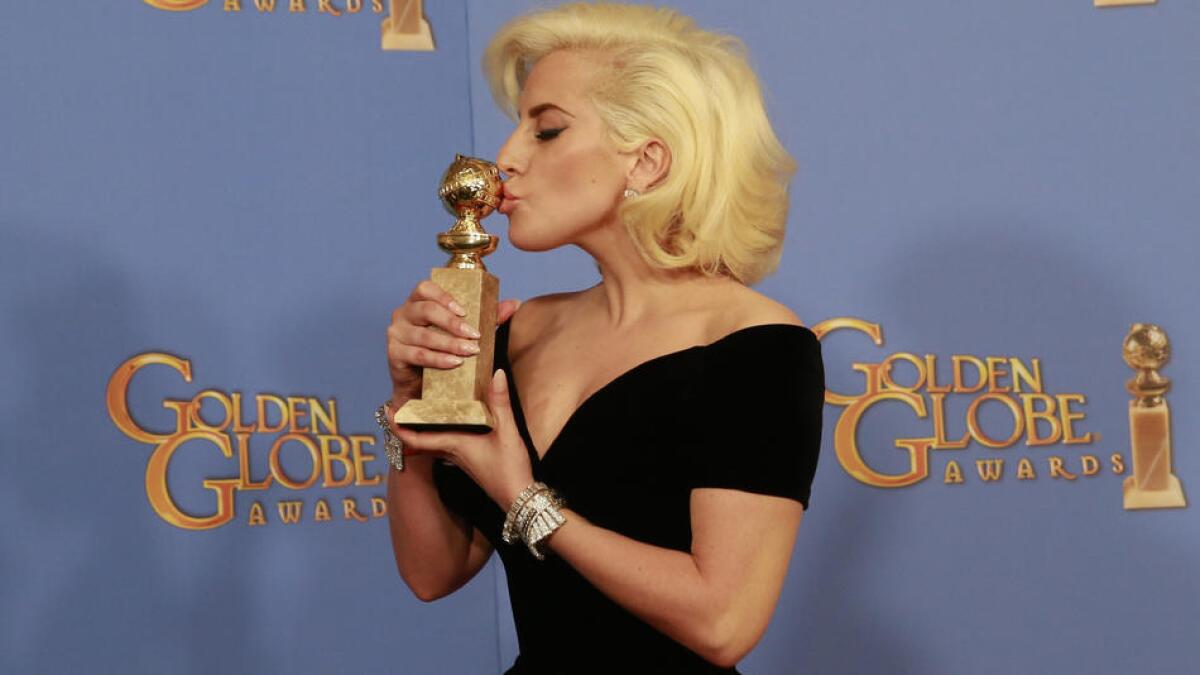 Lady Gaga with her Golden Globe for actress in a miniseries or a motion picture in 2016.