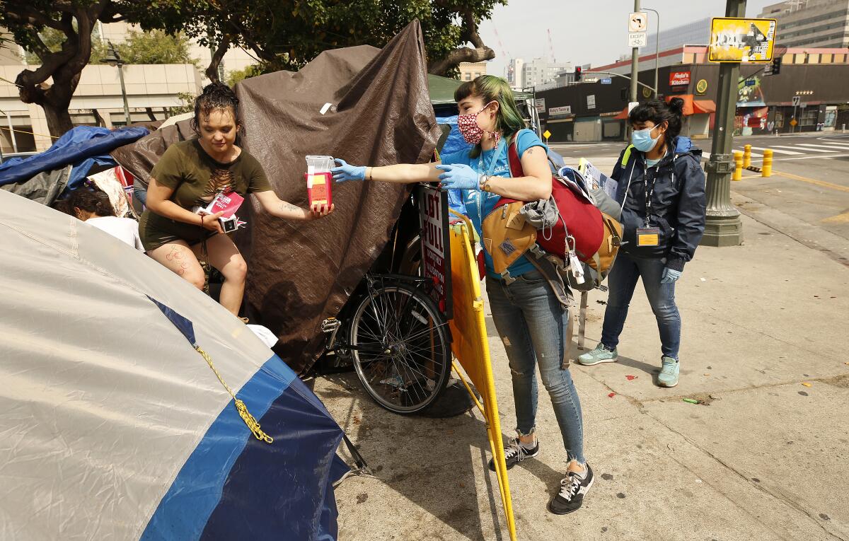 An outreach worker speaks with a homeless person