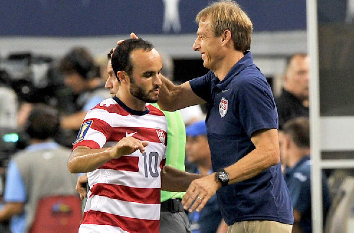 U.S. coach Juergen Klinsmann congratulates midfielder Landon Donovan after substituting for him in a 3-1 victory over Honduras earlier this summer.