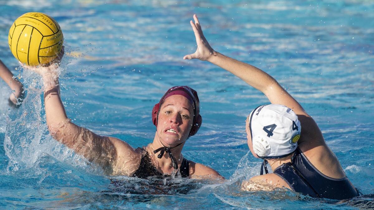 Tea Poljak of Laguna Beach High passes the ball under pressure from Newport Harbor's Morgan Netherton in the quarterfinals of the Holiday Cup on Friday.