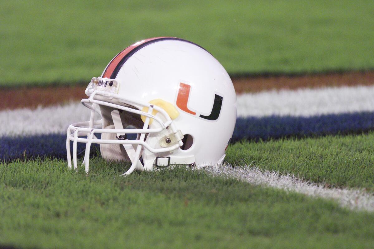 University Of Miami helmet lays on the field.