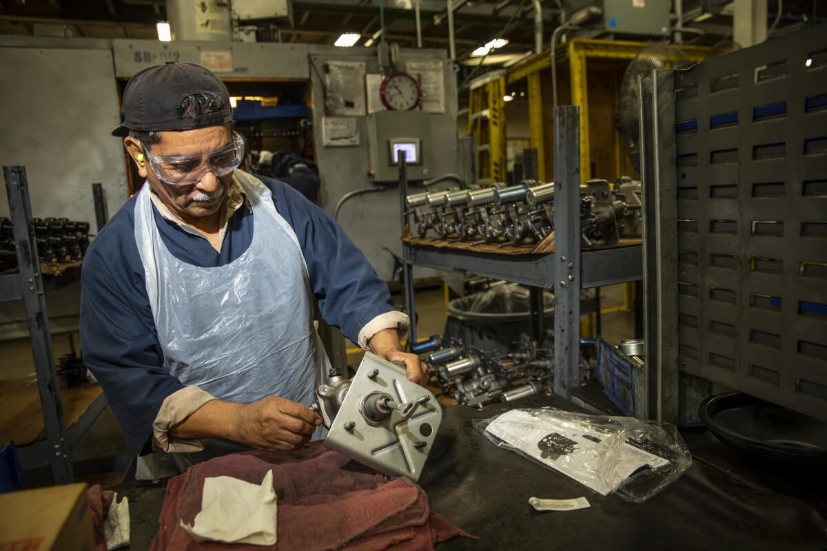 Gilberto Salazar cleans and preps brake hydro boosters for painting inside Motorcar Parts of America’s world headquarters in Torrance.