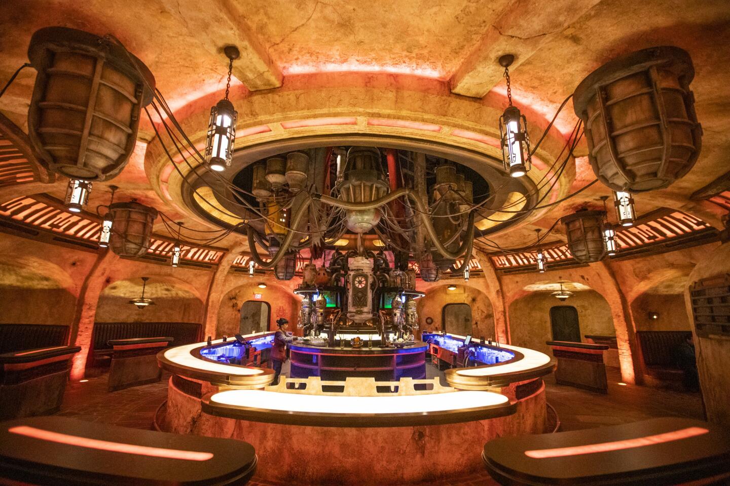 A waitress prepares a drink in Oga's Cantina as media members get a preview during the Star Wars: Galaxy's Edge media day.