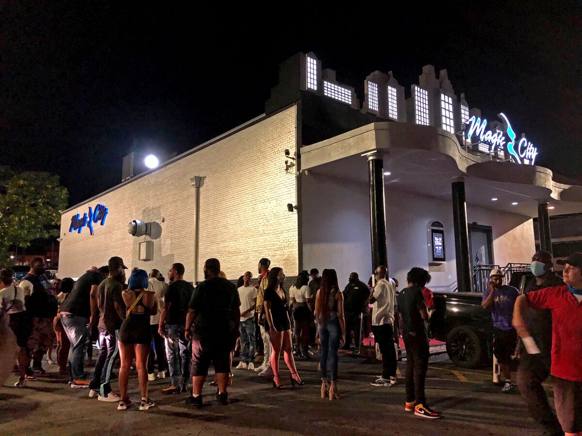 People gather outside the Magic City strip club in Atlanta