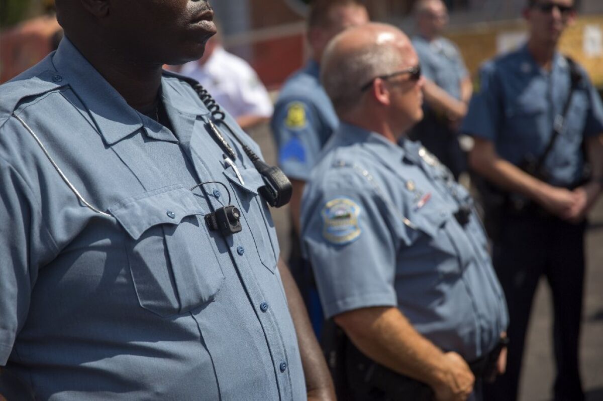 Members of the Ferguson Police department during a rally in Ferguson, Mo.