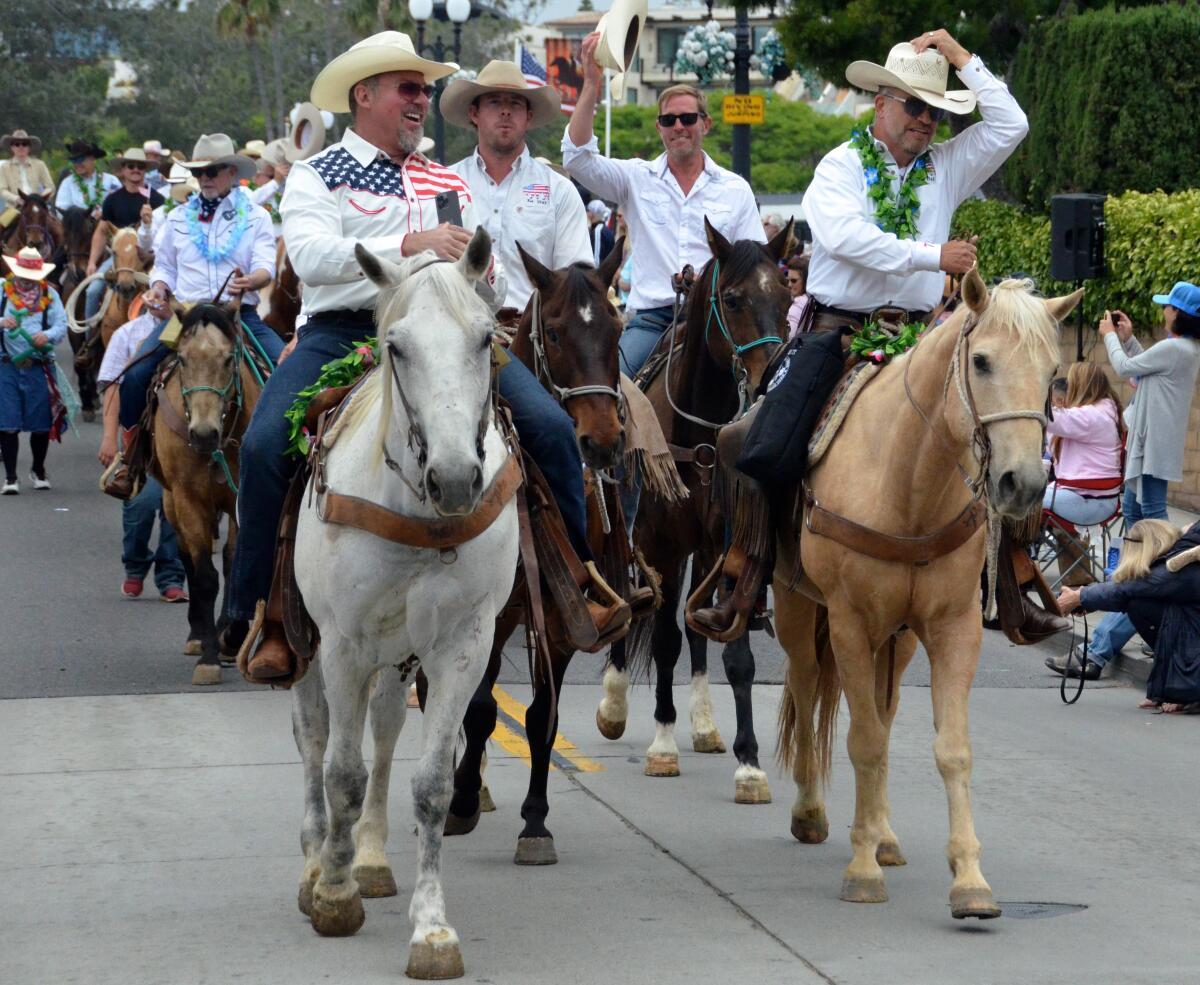 "Balboalleros" cowboys trot down Marine Avenue Sunday during the Balboa Island Parade.