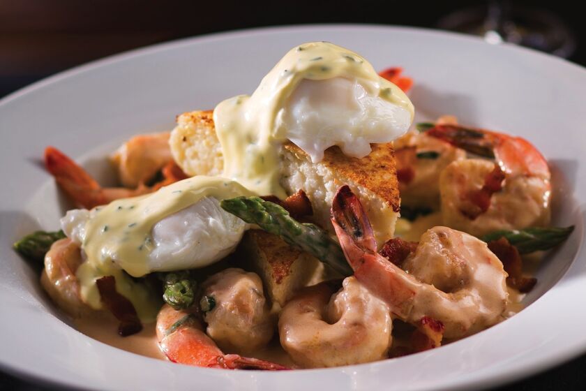 The adult menu at Eddie V's features bananas foster French toast, steak and eggs benedict, seafood chopped salad and shrimp and grits (pictured above).