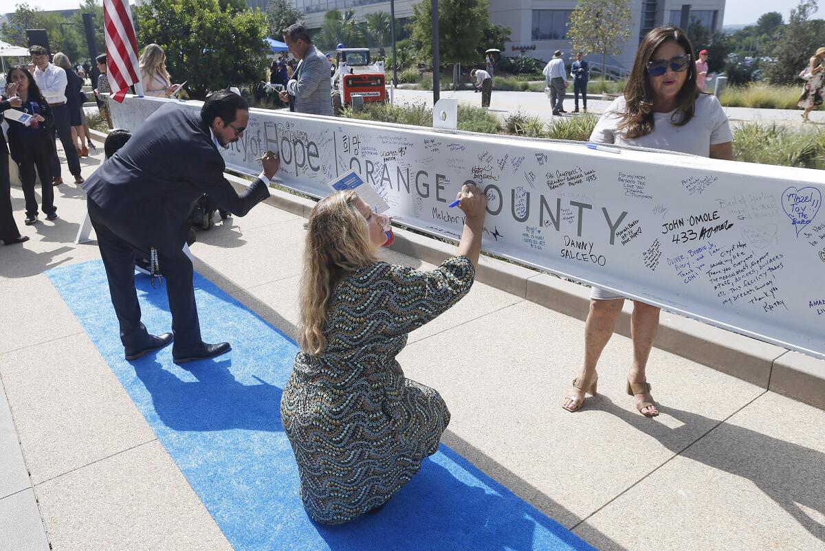Guests sign the final construction beam for City of Hope Orange County Lennar Foundation Cancer Center.