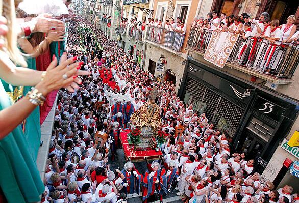 The festival of San Fermín in Pamplona, Spain, draws thousands of people each year. A statue of the patron saint of the city is carried through the streets in an annual procession at the start of the festival. The festival's running of the bulls is one of its main attractions.