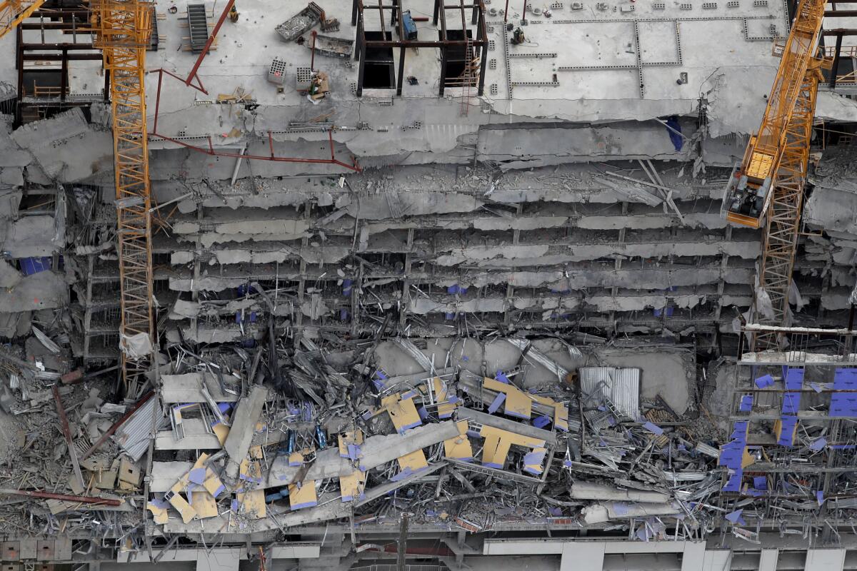 FILE - This aerial photo shows the Hard Rock Hotel, which was under construction, after a fatal partial collapse in New Orleans on Oct. 12, 2019. A New Orleans judge has brought in a mediator to try to work out a settlement with hundreds of people who claim damage from the hotel construction collapse nearly three years ago. Plaintiffs say they were injured, a loved one killed, or their business damaged when upper stories of the planned Hard Rock Hotel collapsed. (AP Photo/Gerald Herbert, File)
