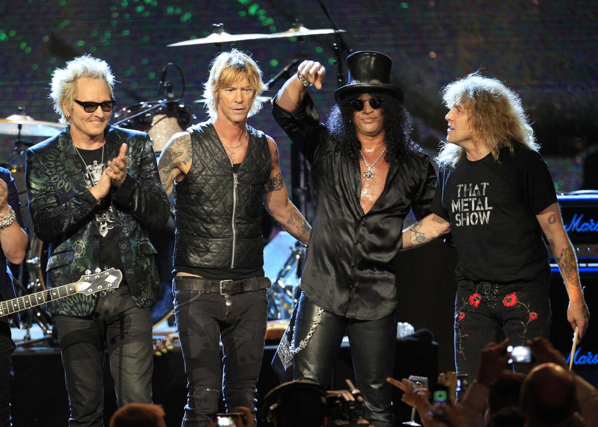 In this April 15, 2012, file photo, Guns N' Roses band members, from left, Matt Sorum, Duff McKagan, Slash and Steven Adler appear onstage during their induction into the Rock and Roll Hall of Fame in Cleveland.