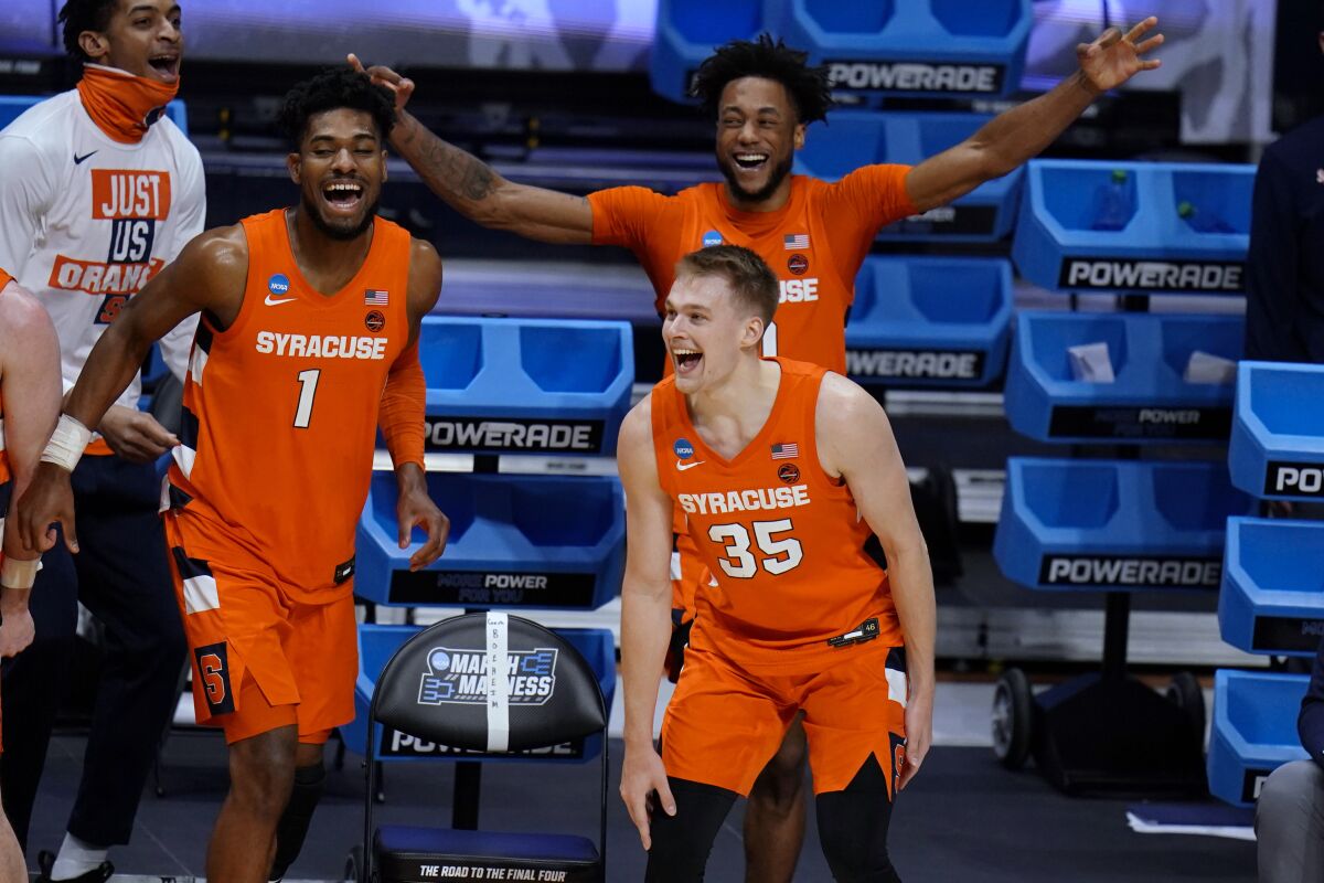 Syracuse's (from left) Quincy Guerrier, Buddy Boeheim and Alan Griffin celebrate a teammate's three-pointer.
