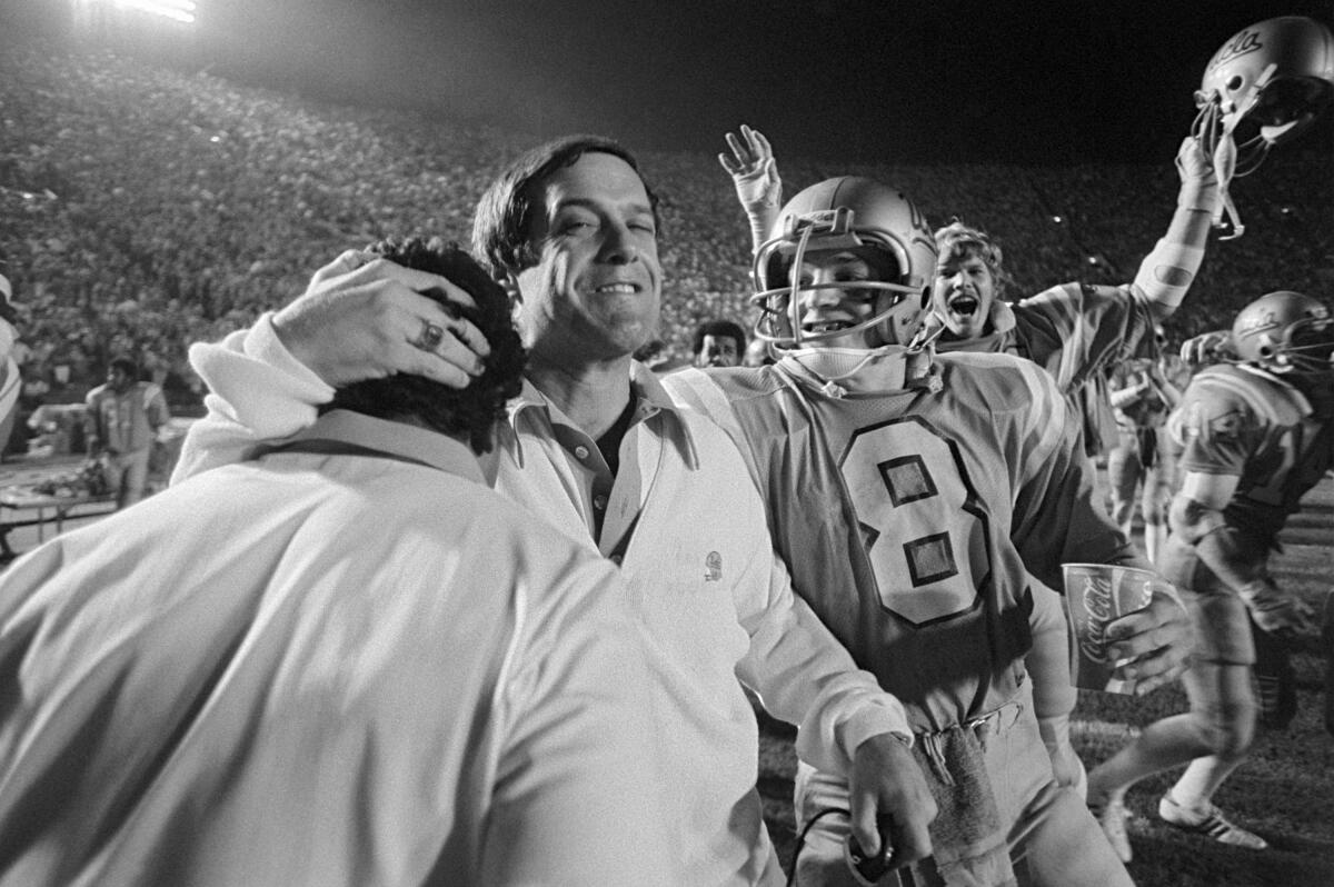 UCLA coach Terry Donohue embraces a sideline companion during a game against USC on Nov. 26, 1977.