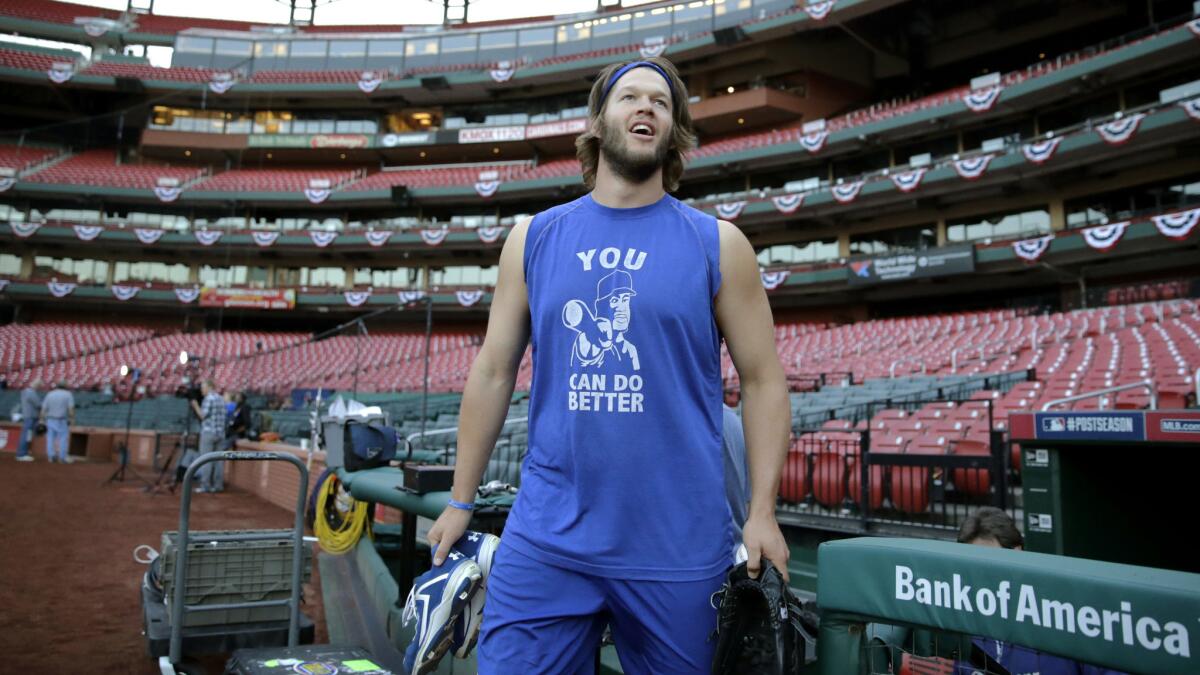 Dodgers pitcher Clayton Kershaw walks onto the field at Busch Stadium before practice Sunday.