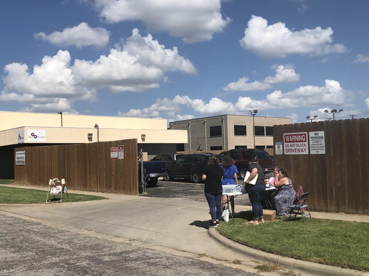 Antiabortion protesters near a parking lot driveway