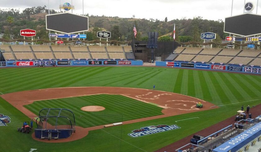 Crews prepare Dodger Stadium before an opening-day game.