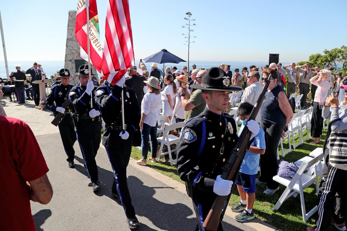 The Laguna Beach Honor Guard retires the colors during a Veterans Day ceremony on Thursday in Laguna Beach.