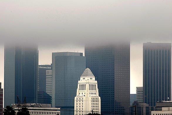 Rain clouds loom over the downtown Los Angeles skyline.